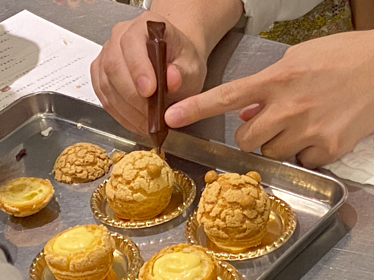 茶色のチョコペンで顔を書く